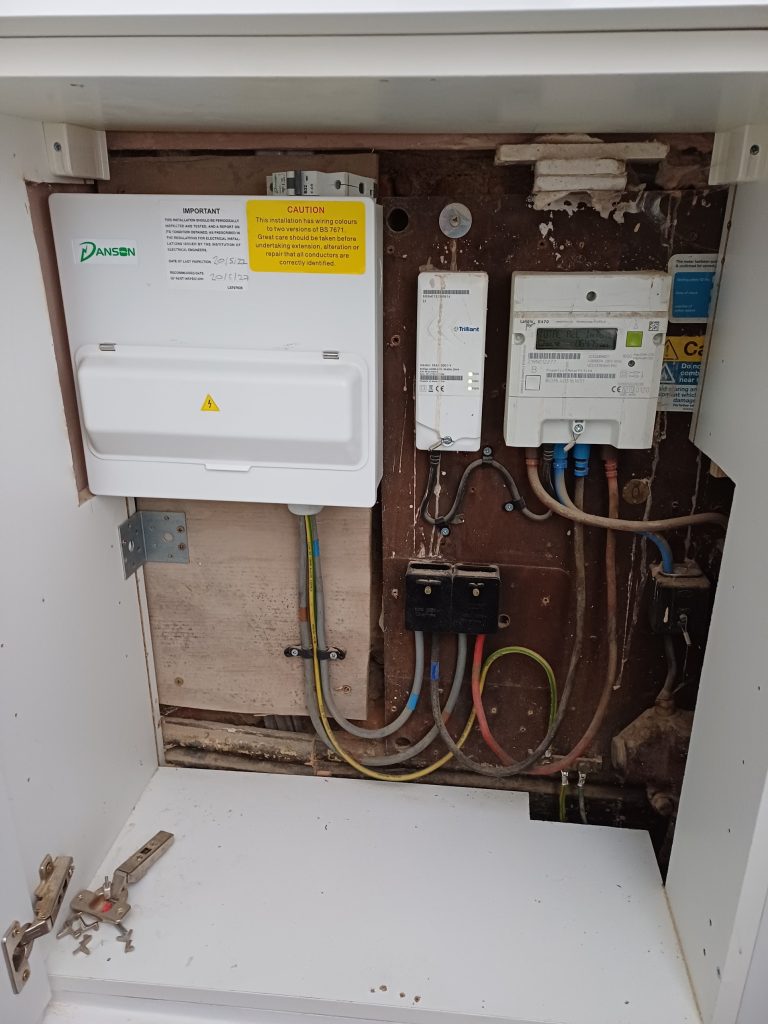 Outdoor meter cupboard holding a consumer unit, an electricity meter and an isolator
